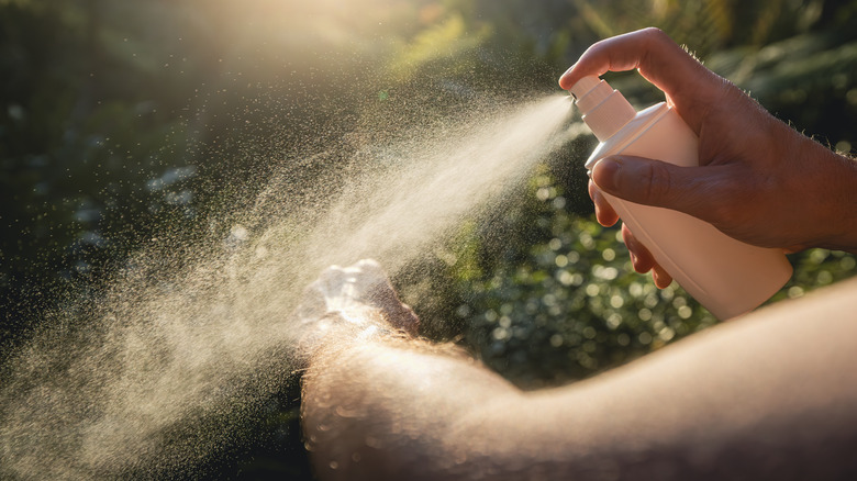 Person spraying repellent 