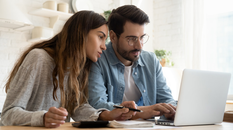 Couple looking at laptop