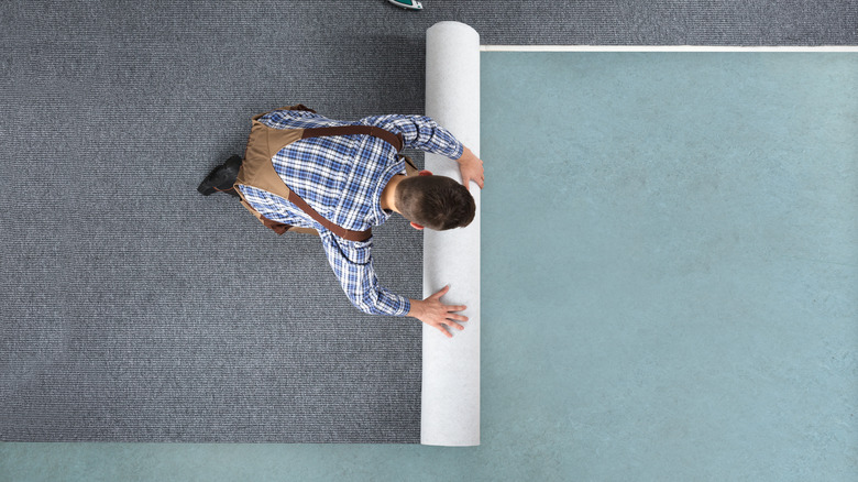 Man rolling carpet