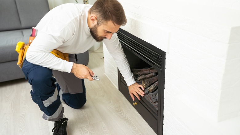 man working on fireplace