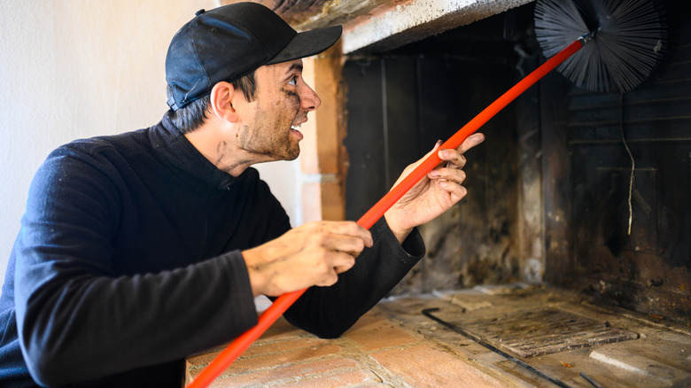 man cleaning chimney