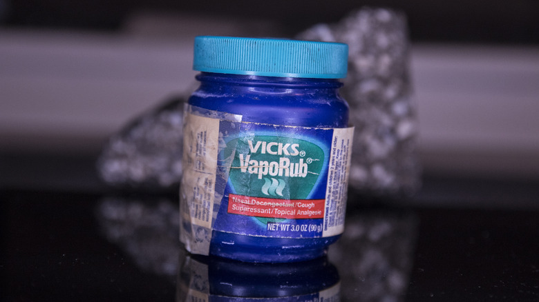 Old blue tub of Vicks VapoRub on shiny surface