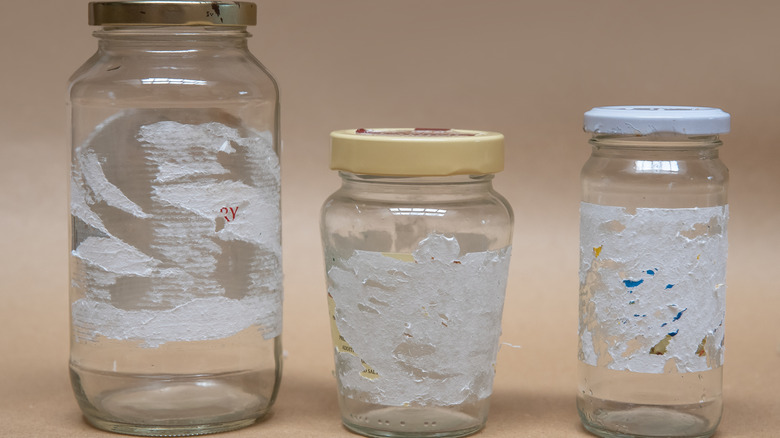 Three clear glass jars with sticker residue