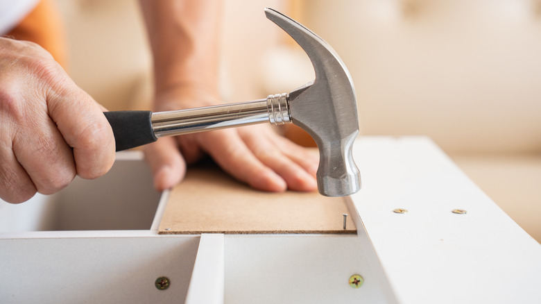 person using hammer