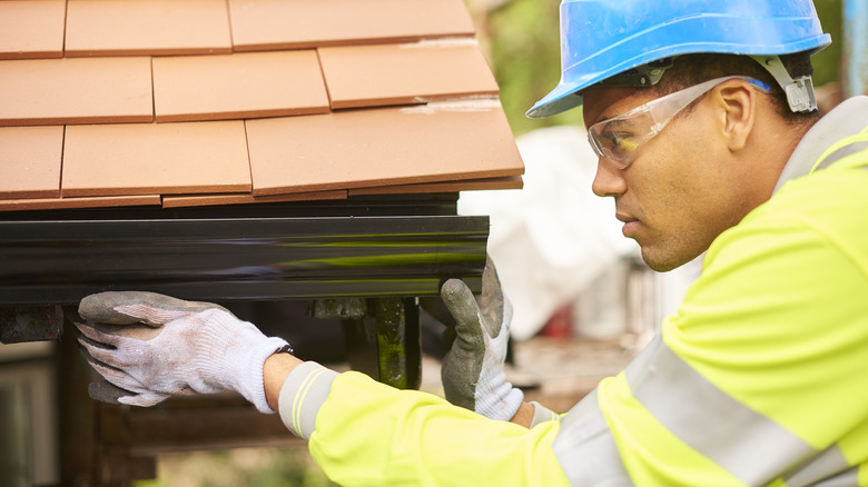 Professional installing gutter