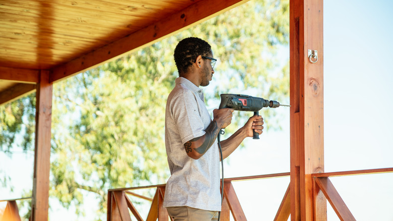 Man working on wooden porch