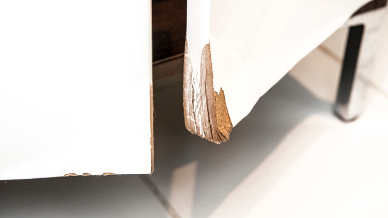 Warped and water-damaged corner of a cabinet door