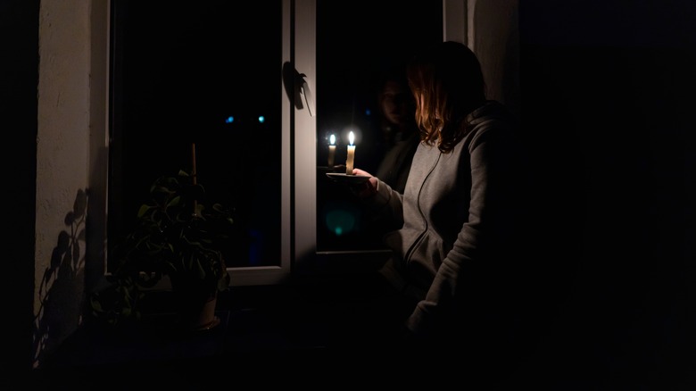 Woman holding candle during power outage