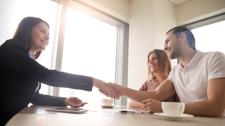 woman and couple shaking hands