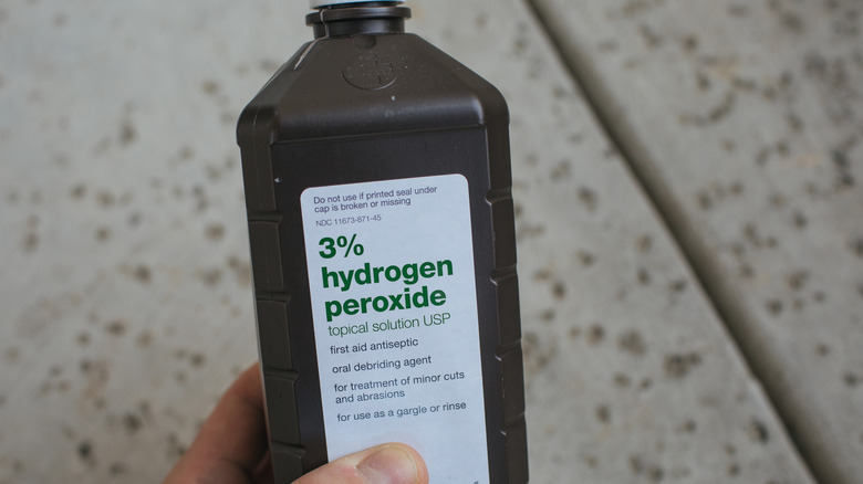 Holding hydrogen peroxide bottle