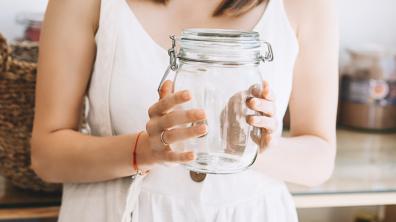 Woman holding glass jar