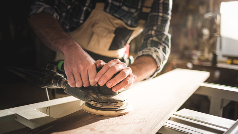 Person sanding wood