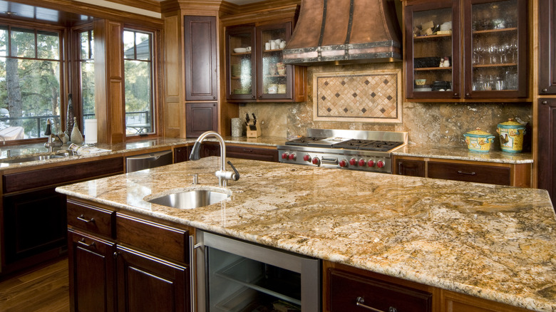 busy looking kitchen with granite