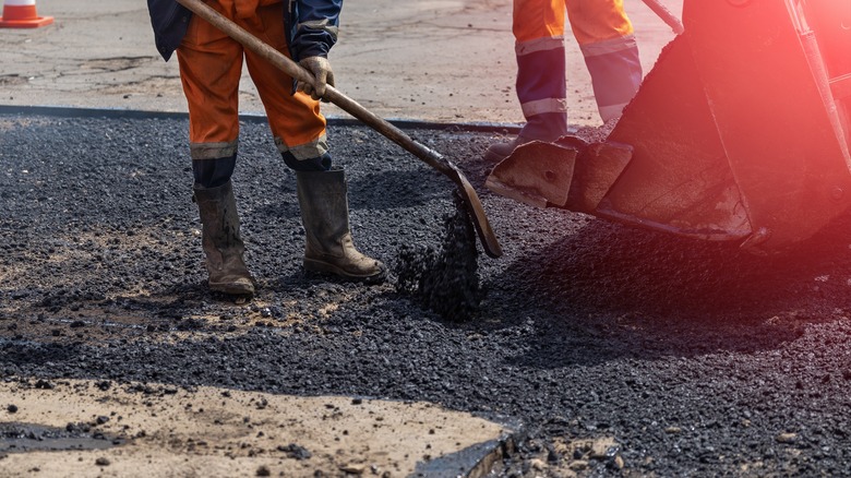 worker pouring asphalt