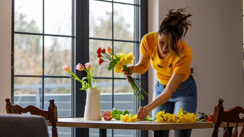 person arranging cut flowers