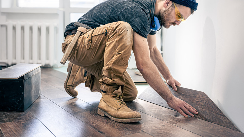 Contractor installing laminate flooring
