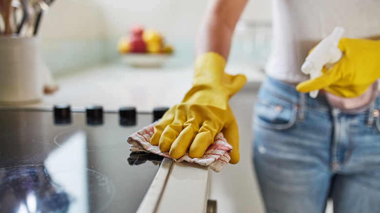 Woman cleaning kitchen surfaces