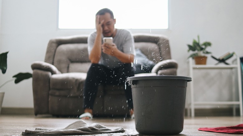 stressed homeowner with leaking roof