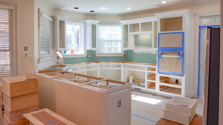 A kitchen interior is in the process of being renovated.