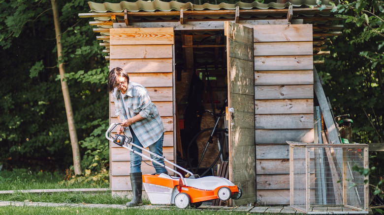 Person moving things out of a shed