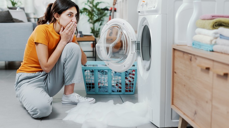 Woman with flooded washing machine