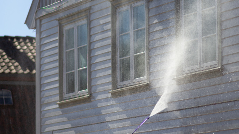 power washing windows on a house