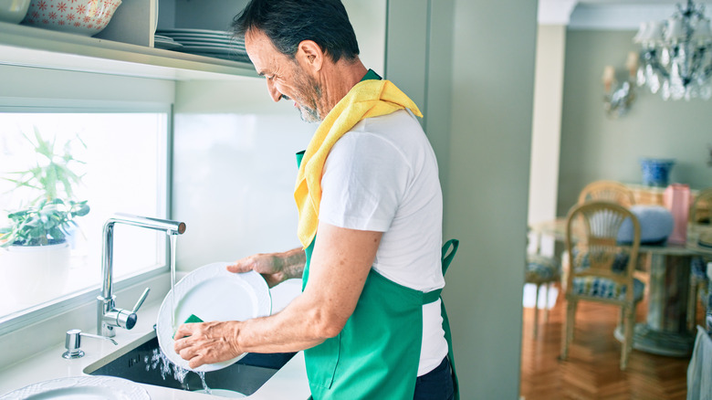 man washing dishes