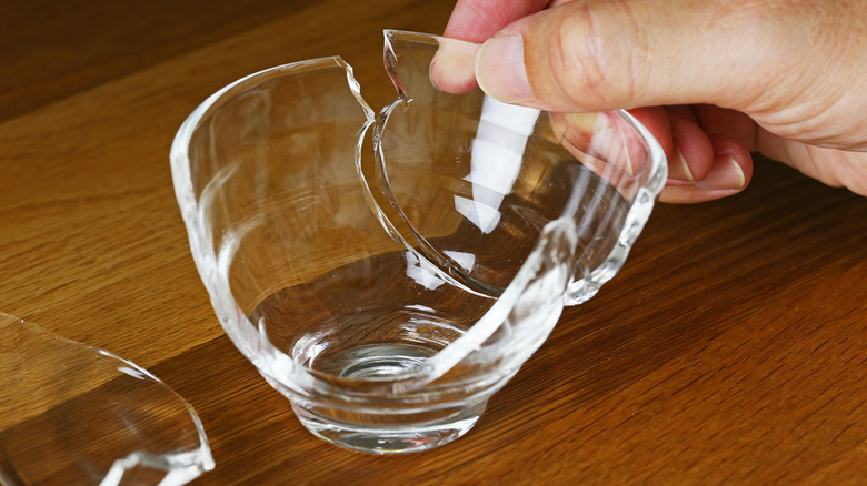 hand repairing broken glass bowl