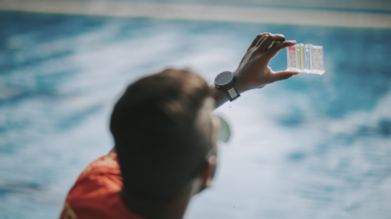 Man tests pool water