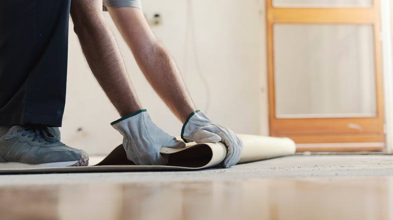 worker removing old flooring