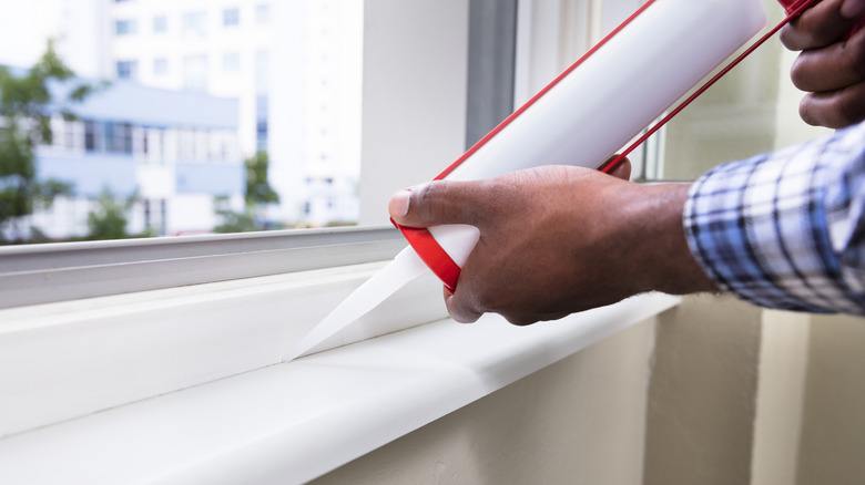 Person sealing window