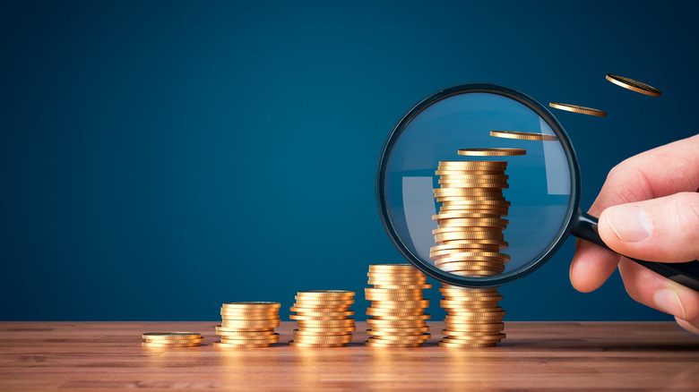 Coins with magnifying glass