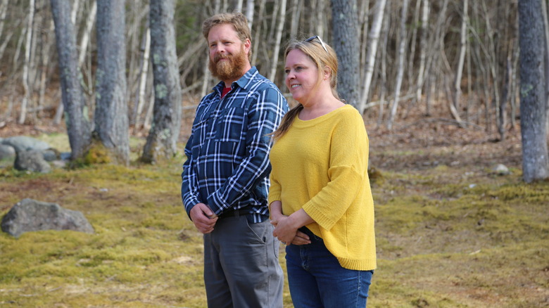 Chase Morrill and Ashley Morrill-Eldridge walking in front of wooded area