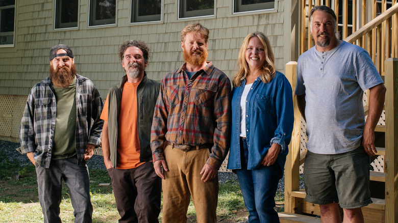 Maine Cabin Masters crew posing outside a cabin