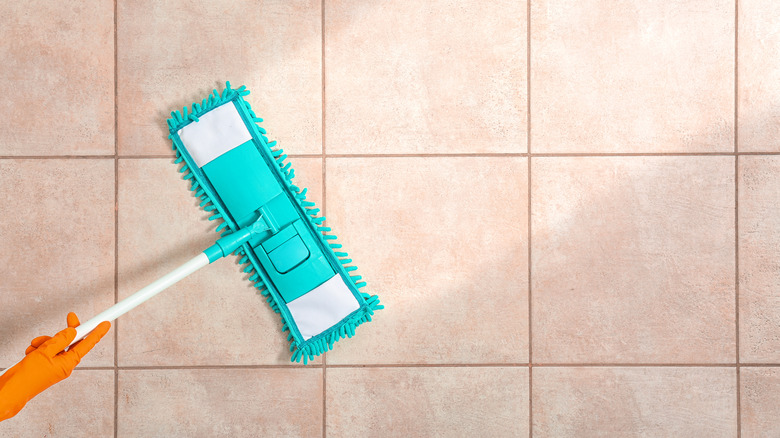 Person mopping tile floor 