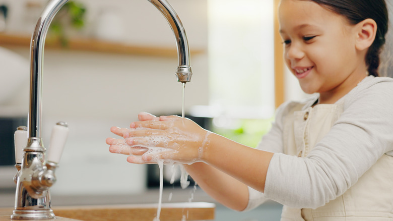 little girl washing her hands