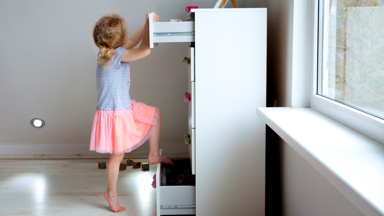 kid climbing on dresser