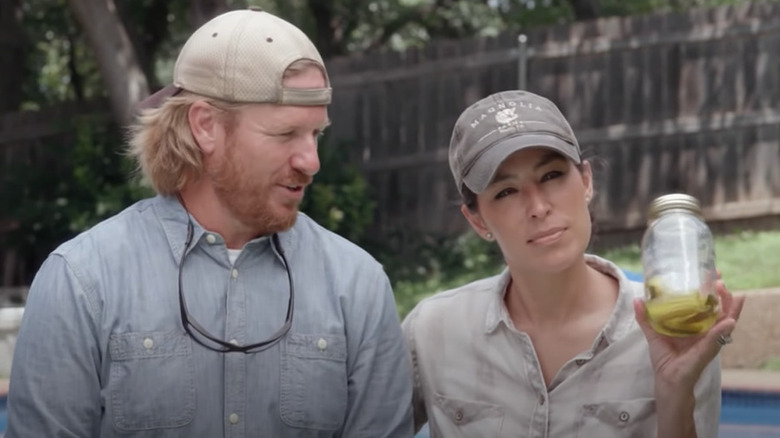 Chip Gaines speaks as Joanna Gaines holds up a pickle jar