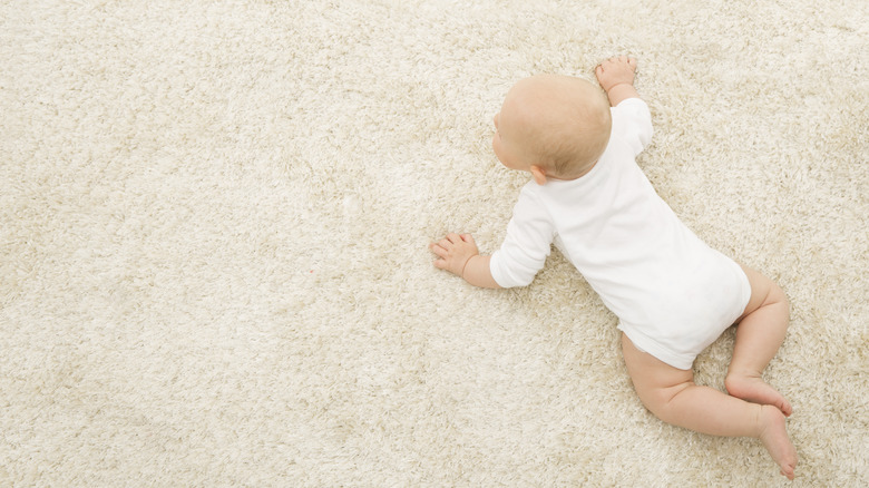 Baby crawling on carpet