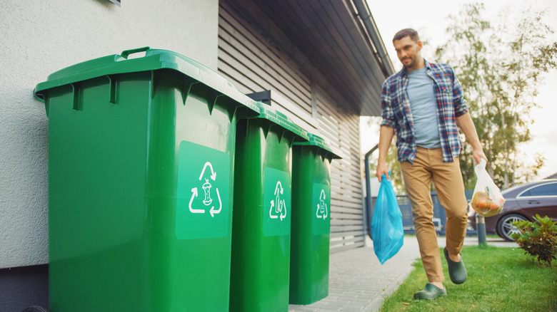 Person carrying trash bags