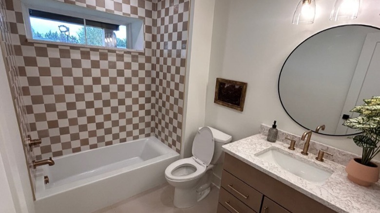 bathroom with checkerboard wall tile