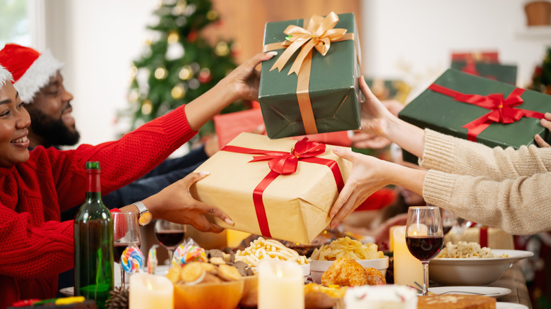 Family happily exchanging gifts at home