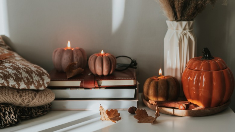 Pumpkin candles on shelf