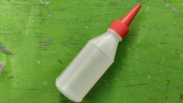 vinegar in a plastic bottle on green surface