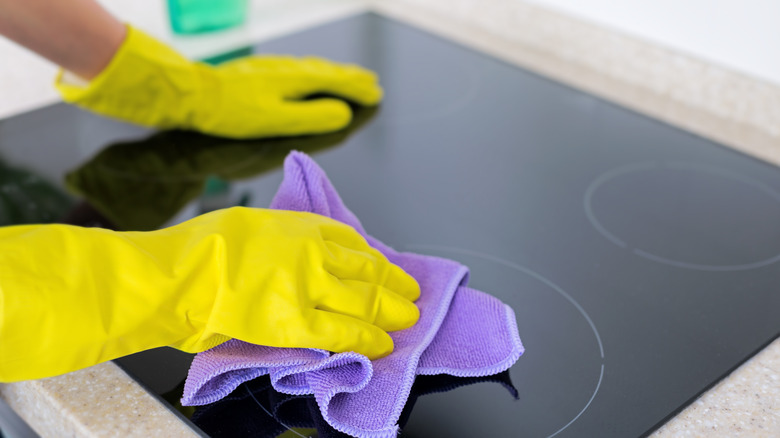 Person wiping stovetop