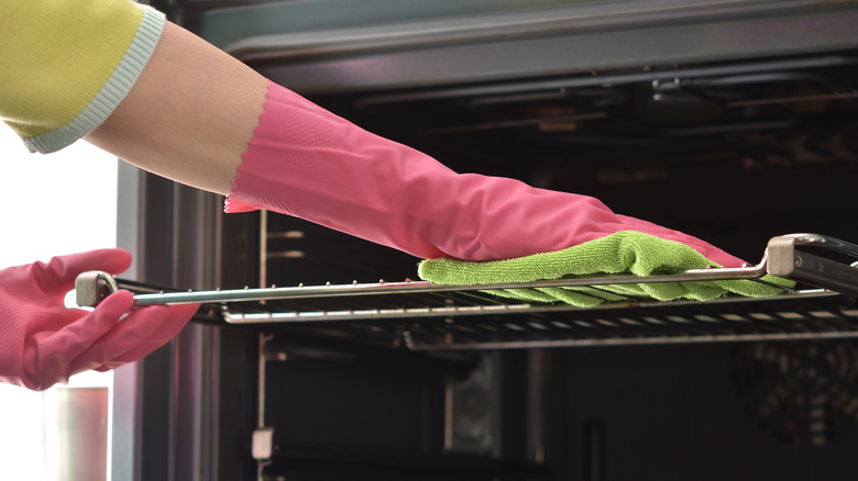 Woman cleaning oven rack