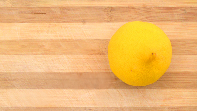 cut lemon on butcher block