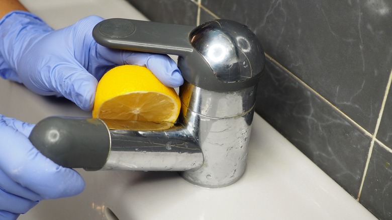 Cleaning a faucet with lemon 