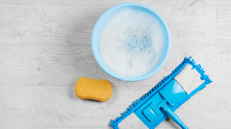 cleaning floor with bucket