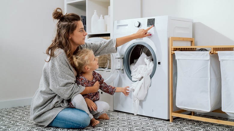 Mom and daughter doing laundry